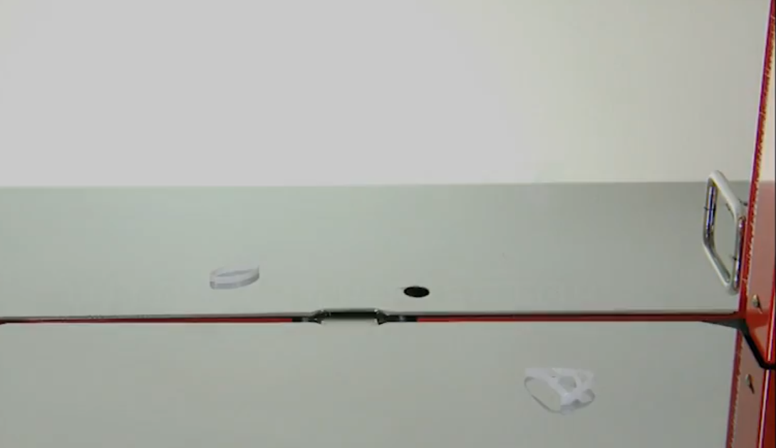 What is an auto loop ejector on a strapping machine?